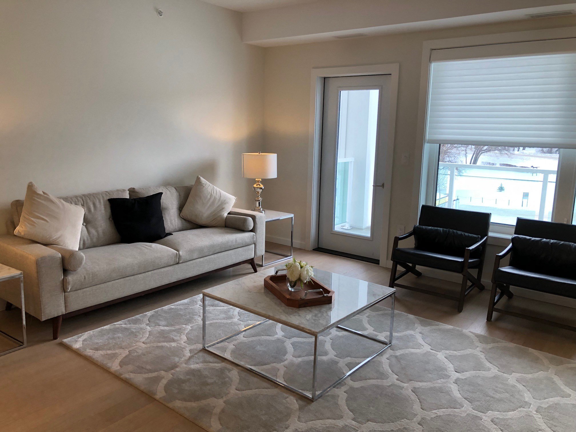 a living room with couches and a glass coffee table
